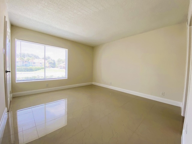 815 W Boynton Beach Blvd Unit 7-102, Boynton Beach, FL 33426 - spare room with a textured ceiling and baseboards