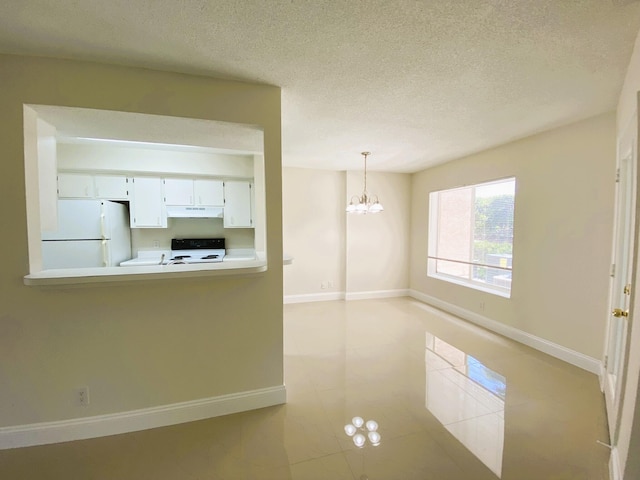 815 W Boynton Beach Blvd Unit 7-102, Boynton Beach, FL 33426 - kitchen with white appliances, under cabinet range hood, light countertops, a chandelier, and white cabinets