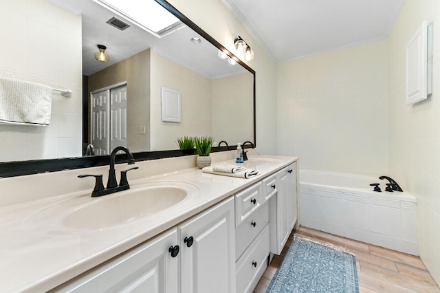 5210 NW 53rd Ave, Coconut Creek, FL 33073 - full bathroom featuring double vanity, wood finished floors, and a bath