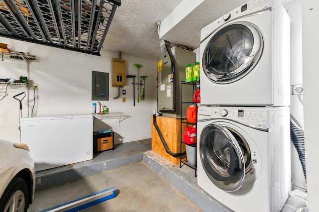 5210 NW 53rd Ave, Coconut Creek, FL 33073 - laundry area with stacked washer and clothes dryer, electric panel, and a textured ceiling