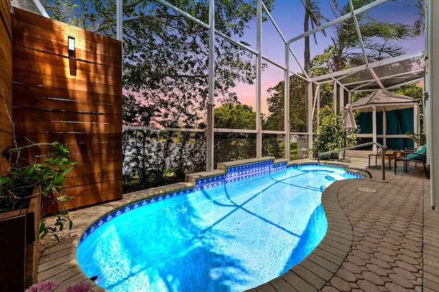 5210 NW 53rd Ave, Coconut Creek, FL 33073 - pool at dusk with an outdoor pool, a gazebo, a patio, and glass enclosure