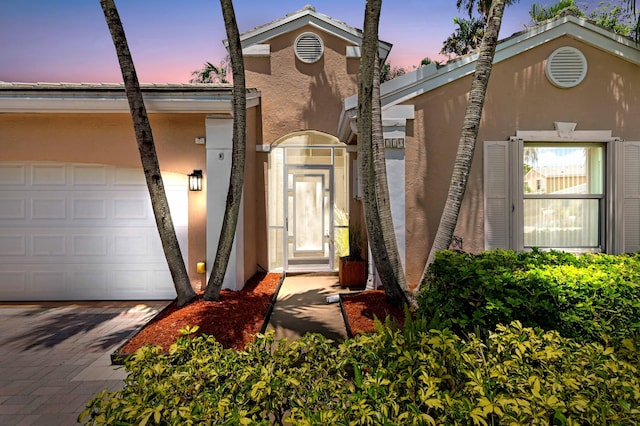 5210 NW 53rd Ave, Coconut Creek, FL 33073 - view of front of home with stucco siding, decorative driveway, and a garage