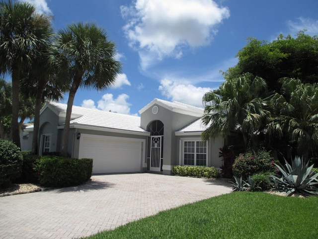 6314 Water Lilly Ln, Boynton Beach, FL 33437 - single story home with a garage, driveway, stucco siding, and a tile roof