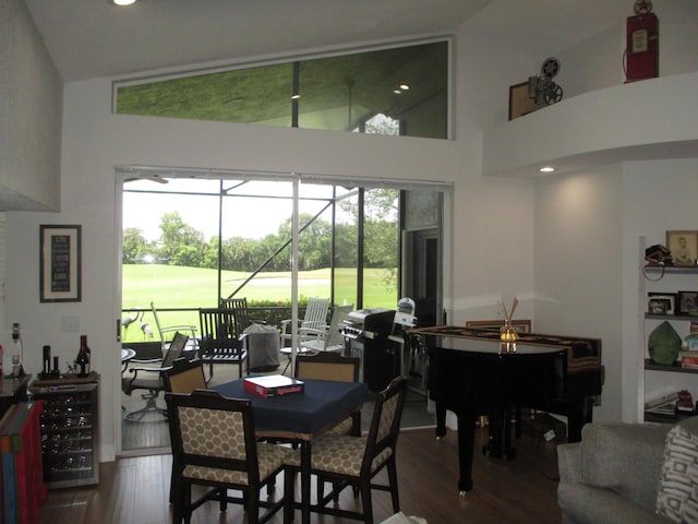 6314 Water Lilly Ln, Boynton Beach, FL 33437 - dining space featuring wine cooler, wood finished floors, view of golf course, high vaulted ceiling, and recessed lighting
