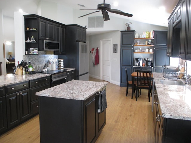 6314 Water Lilly Ln, Boynton Beach, FL 33437 - kitchen featuring open shelves, dark cabinetry, appliances with stainless steel finishes, and lofted ceiling