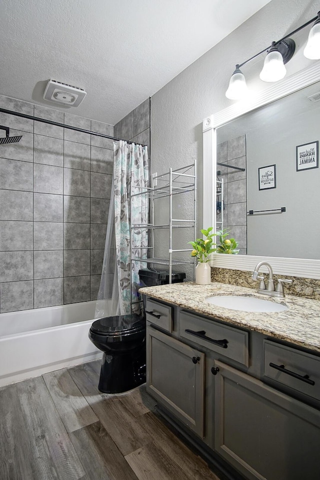 372 NE Ardsley Dr, Port Saint Lucie, FL 34983 - full bath with vanity, shower / tub combo, wood finished floors, a textured wall, and a textured ceiling