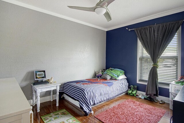 372 NE Ardsley Dr, Port Saint Lucie, FL 34983 - bedroom featuring ornamental molding, wood finished floors, and ceiling fan