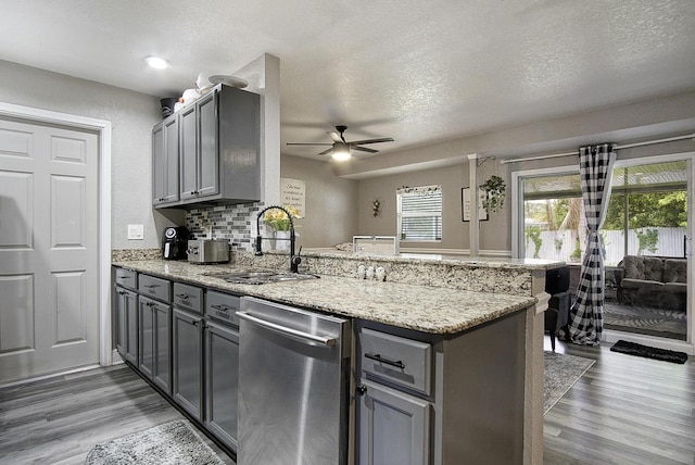 372 NE Ardsley Dr, Port Saint Lucie, FL 34983 - kitchen featuring dishwasher, a peninsula, gray cabinets, a ceiling fan, and light wood-style floors