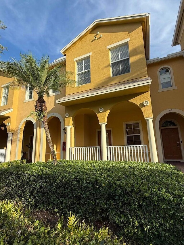 108 W Pigeon Plum Dr W Unit 102, Jupiter, FL 33458 - view of front of home featuring stucco siding and covered porch