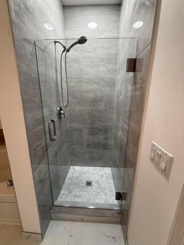 108 W Pigeon Plum Dr W Unit 102, Jupiter, FL 33458 - bathroom featuring a stall shower and marble finish flooring