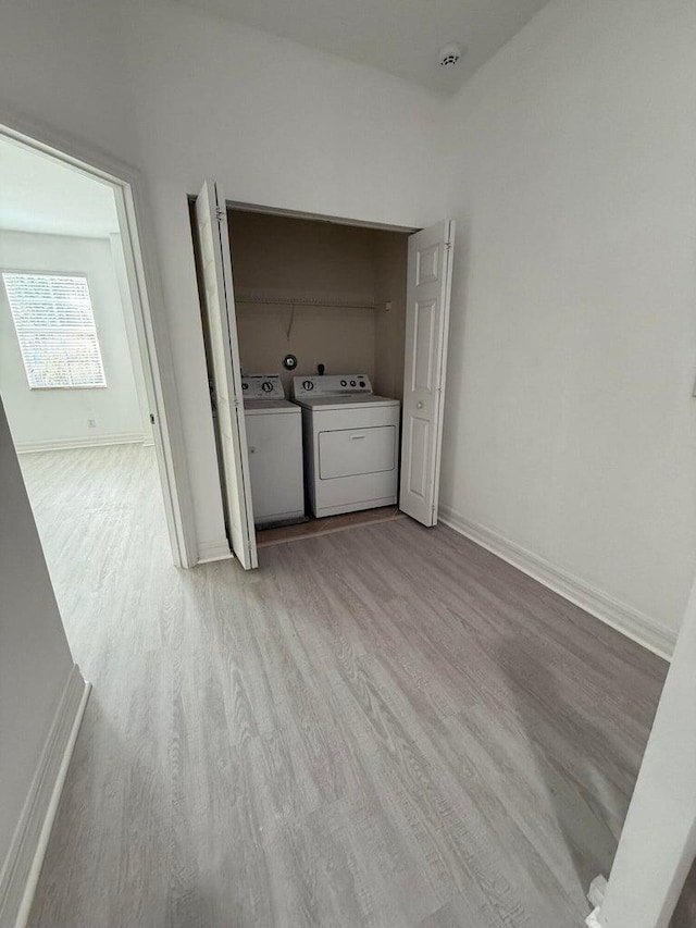 108 W Pigeon Plum Dr W Unit 102, Jupiter, FL 33458 - washroom with washer and clothes dryer and light wood finished floors