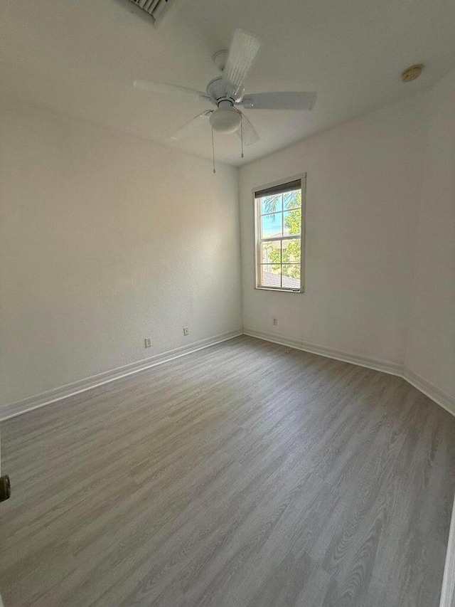 108 W Pigeon Plum Dr W Unit 102, Jupiter, FL 33458 - spare room featuring wood finished floors, a smoke detector, and a ceiling fan