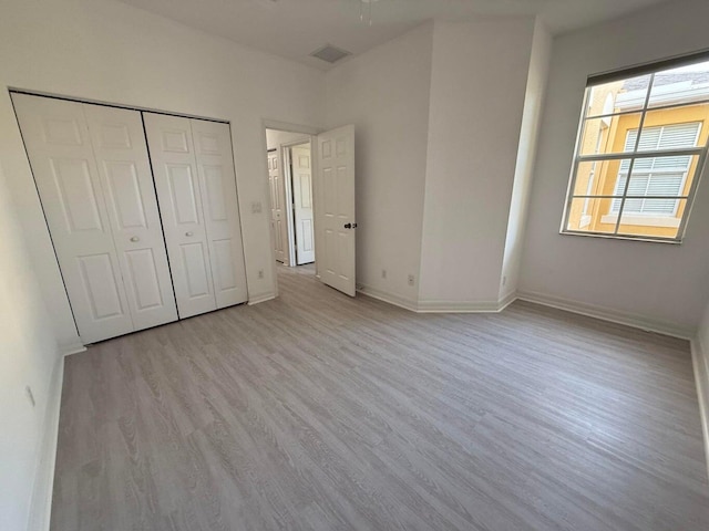108 W Pigeon Plum Dr W Unit 102, Jupiter, FL 33458 - unfurnished bedroom with light wood-type flooring and a closet