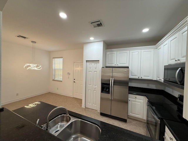108 W Pigeon Plum Dr W Unit 102, Jupiter, FL 33458 - kitchen featuring appliances with stainless steel finishes, white cabinetry, dark countertops, recessed lighting, and hanging light fixtures