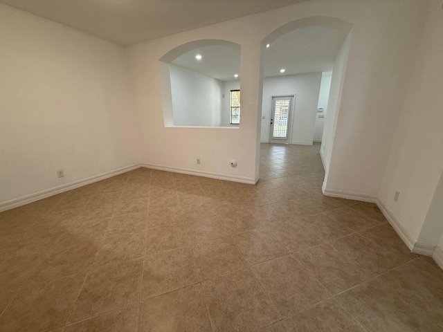 108 W Pigeon Plum Dr W Unit 102, Jupiter, FL 33458 - tiled spare room featuring arched walkways and recessed lighting