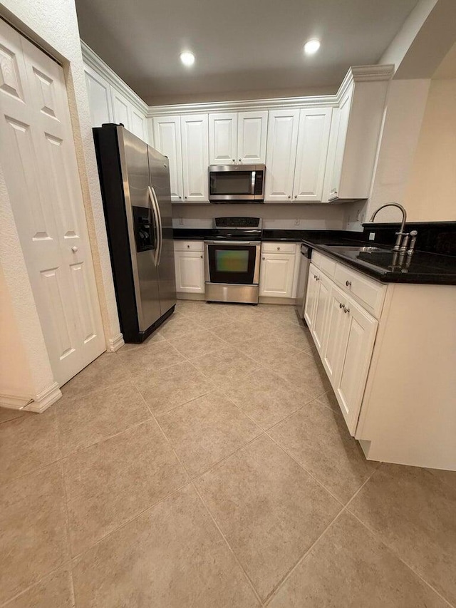 108 W Pigeon Plum Dr W Unit 102, Jupiter, FL 33458 - kitchen featuring stainless steel appliances, dark countertops, white cabinetry, light tile patterned floors, and recessed lighting