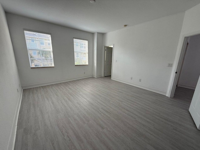 108 W Pigeon Plum Dr W Unit 102, Jupiter, FL 33458 - empty room featuring wood finished floors and baseboards