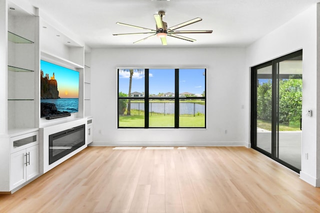17380 Rainstream Rd, Boca Raton, FL 33496 - unfurnished living room featuring light wood-type flooring, ceiling fan, and built in shelves