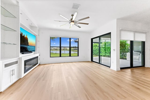 17380 Rainstream Rd, Boca Raton, FL 33496 - unfurnished living room featuring ceiling fan and light wood-style flooring