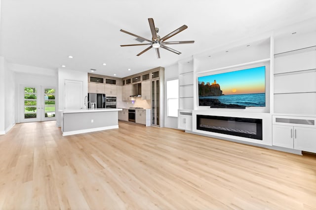 17380 Rainstream Rd, Boca Raton, FL 33496 - unfurnished living room featuring a ceiling fan, recessed lighting, light wood-type flooring, and a glass covered fireplace