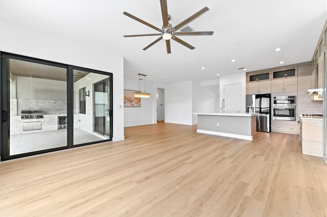17380 Rainstream Rd, Boca Raton, FL 33496 - unfurnished living room with light wood finished floors, ceiling fan, and recessed lighting