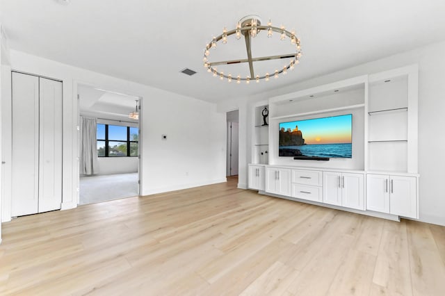17380 Rainstream Rd, Boca Raton, FL 33496 - unfurnished living room featuring light wood-style floors and a chandelier