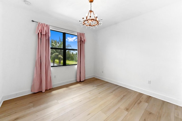 17380 Rainstream Rd, Boca Raton, FL 33496 - empty room featuring a chandelier, light wood-type flooring, and a smoke detector
