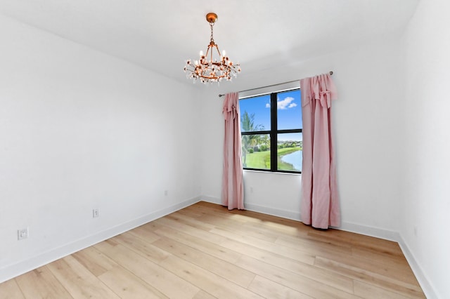 17380 Rainstream Rd, Boca Raton, FL 33496 - unfurnished room featuring a chandelier and light wood-style flooring