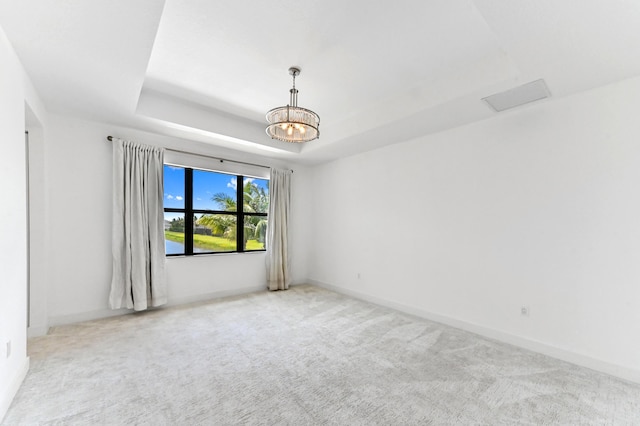 17380 Rainstream Rd, Boca Raton, FL 33496 - spare room featuring light colored carpet, a raised ceiling, and a chandelier