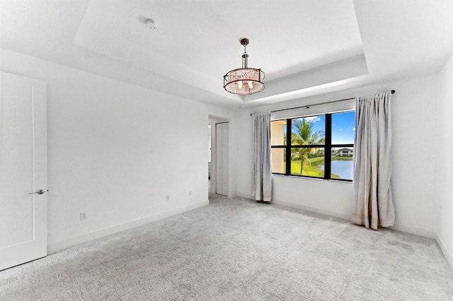 17380 Rainstream Rd, Boca Raton, FL 33496 - unfurnished room with a raised ceiling, carpet floors, a chandelier, and a smoke detector