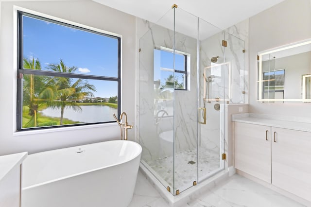 17380 Rainstream Rd, Boca Raton, FL 33496 - bathroom with vanity, marble look tiles, a freestanding tub, a marble finish shower, and a water view