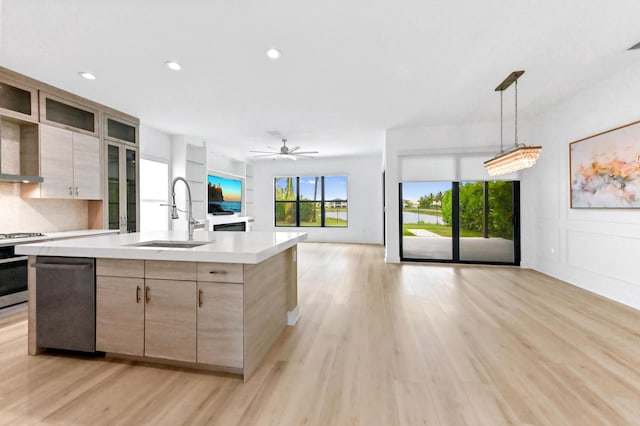 17380 Rainstream Rd, Boca Raton, FL 33496 - kitchen featuring light countertops, dishwasher, range, light wood-style flooring, and open floor plan