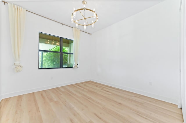 17380 Rainstream Rd, Boca Raton, FL 33496 - spare room featuring a chandelier and light wood-style flooring