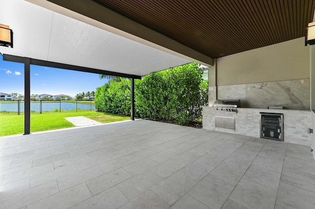 17380 Rainstream Rd, Boca Raton, FL 33496 - view of patio with beverage cooler, a water view, and an outdoor kitchen