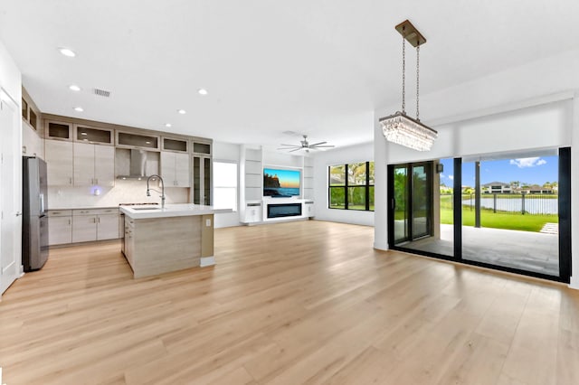 17380 Rainstream Rd, Boca Raton, FL 33496 - kitchen with freestanding refrigerator, ceiling fan, light countertops, recessed lighting, and wall chimney exhaust hood