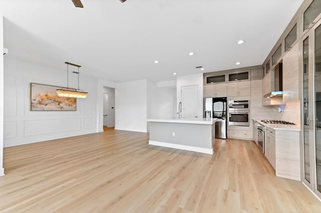 17380 Rainstream Rd, Boca Raton, FL 33496 - kitchen featuring fridge with ice dispenser, modern cabinets, light countertops, light wood-style flooring, and recessed lighting