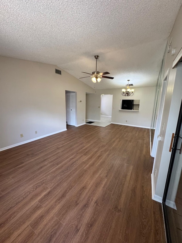 7626 Tahiti Ln Unit 204, Lake Worth, FL 33467 - unfurnished living room with a ceiling fan, dark wood-type flooring, a textured ceiling, lofted ceiling, and a chandelier