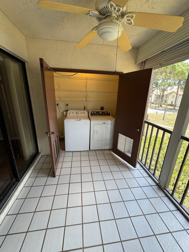 7626 Tahiti Ln Unit 204, Lake Worth, FL 33467 - laundry area featuring washer and clothes dryer, a ceiling fan, a textured wall, light tile patterned flooring, and a textured ceiling