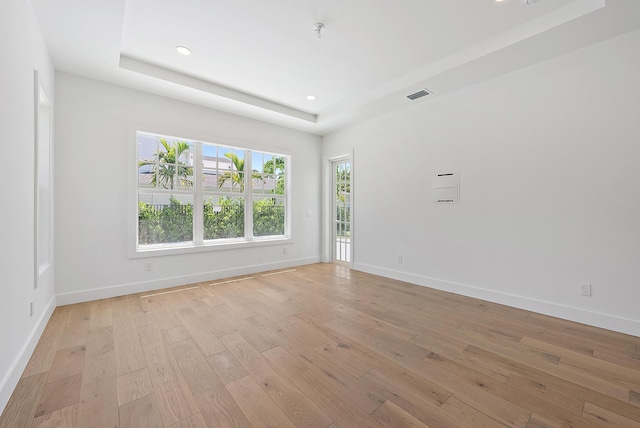 295 Austin Ln, West Palm Beach, FL 33401 - unfurnished room featuring a tray ceiling, light wood-type flooring, recessed lighting, and a pendent fire sprinkler