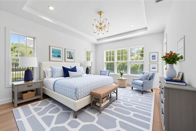 295 Austin Ln, West Palm Beach, FL 33401 - bedroom featuring a tray ceiling, a chandelier, light wood-style flooring, multiple windows, and recessed lighting