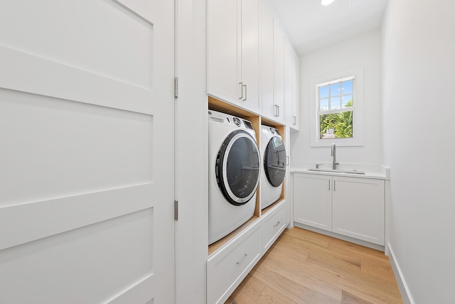 295 Austin Ln, West Palm Beach, FL 33401 - washroom with independent washer and dryer, cabinet space, and light wood-type flooring