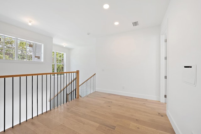 295 Austin Ln, West Palm Beach, FL 33401 - corridor with an upstairs landing, light wood-style flooring, and recessed lighting
