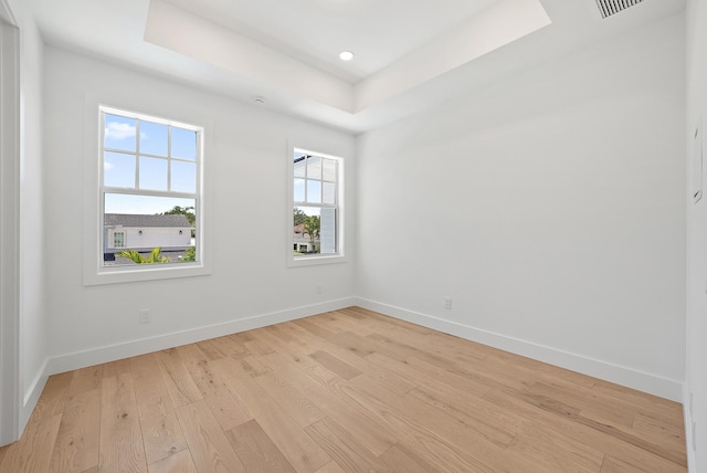 295 Austin Ln, West Palm Beach, FL 33401 - spare room featuring a raised ceiling, light wood-style floors, and recessed lighting