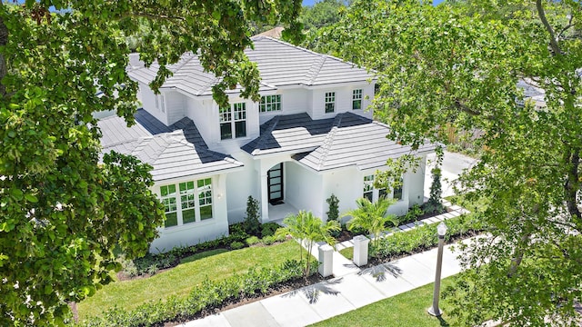 295 Austin Ln, West Palm Beach, FL 33401 - back of property with stucco siding, a yard, and a tiled roof