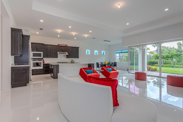 10815 Stellar Cir, Palm Beach Gardens, FL 33412 - living area with a raised ceiling, recessed lighting, ornamental molding, and light tile patterned floors
