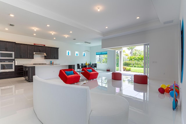 10815 Stellar Cir, Palm Beach Gardens, FL 33412 - living area with light tile patterned floors, healthy amount of natural light, recessed lighting, crown molding, and a tray ceiling