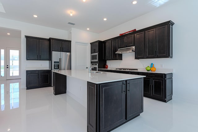 10815 Stellar Cir, Palm Beach Gardens, FL 33412 - kitchen with stainless steel appliances, under cabinet range hood, light tile patterned floors, a large island, and light countertops