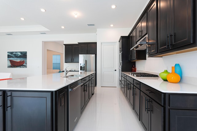 10815 Stellar Cir, Palm Beach Gardens, FL 33412 - kitchen with under cabinet range hood, appliances with stainless steel finishes, a spacious island, recessed lighting, and light tile patterned floors