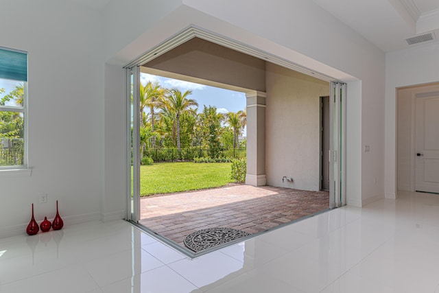 10815 Stellar Cir, Palm Beach Gardens, FL 33412 - doorway to outside with tile patterned floors and plenty of natural light