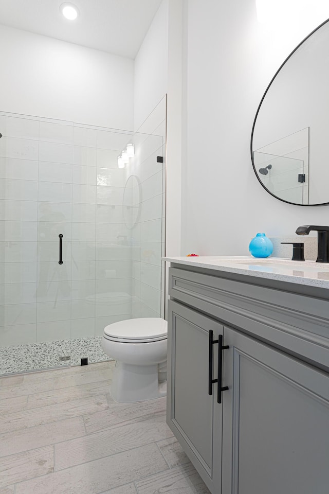 10815 Stellar Cir, Palm Beach Gardens, FL 33412 - bathroom with vanity, a stall shower, recessed lighting, and wood finished floors